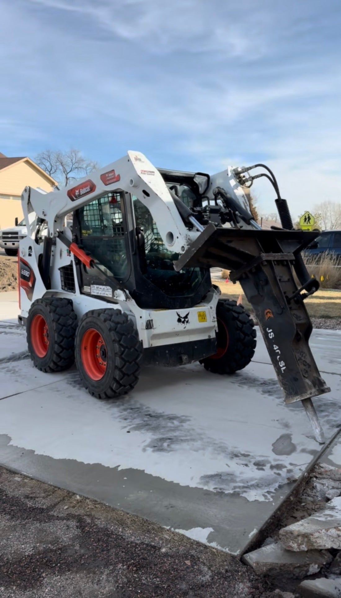 bobcat skid steer removing concrete driveway in Denver
