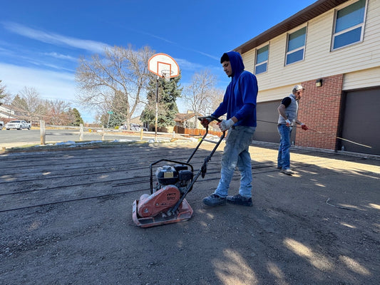 Compacting road base before installing a residential concrete driveway in Denver Colorado