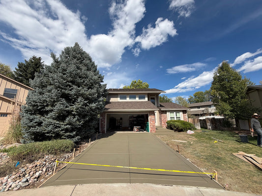 Newly replaced concrete driveway with broom finish and control joints in Englewood, Colorado