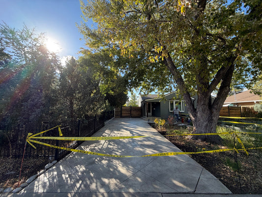 Decorative concrete driveway in Denver, Colorado, restored with Brickform Adobe Buff antiquing and low-gloss concrete sealer by Pristine Concrete Denver.