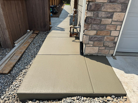 Finished concrete walkway with broom finish and control joints in Brighton Colorado
