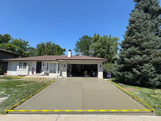 Newly poured concrete driveway in Denver with 9 inch perimeter border and control joints