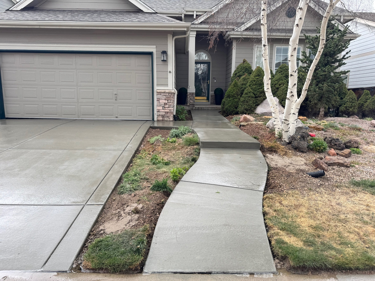 Curved concrete walkway leading to front door Parker CO