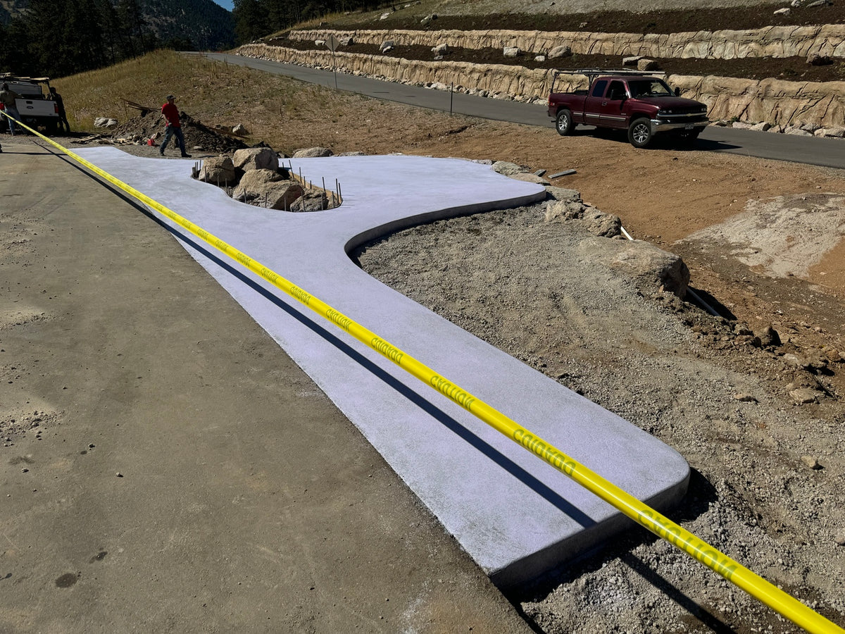 Freshly placed community mailbox concrete pad at a new residential development in Boulder, Colorado