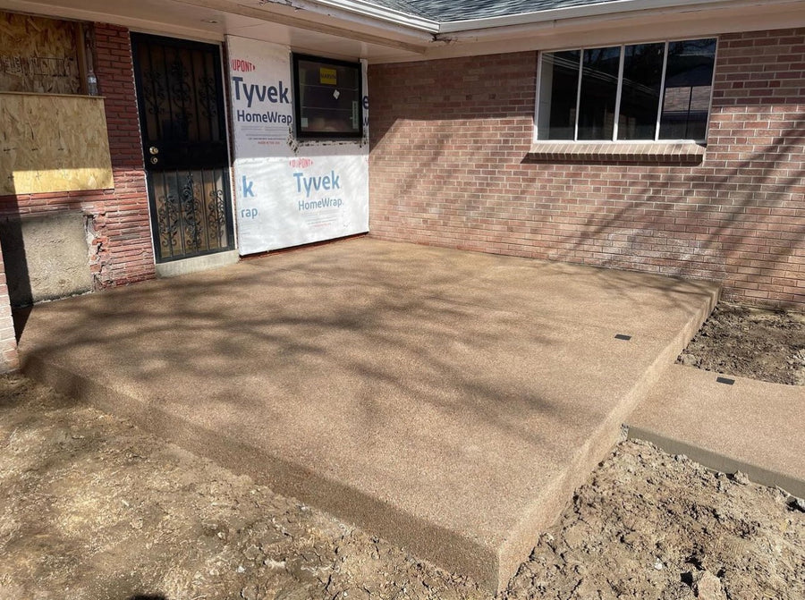 New sand finish concrete front porch slab at a Denver-area home