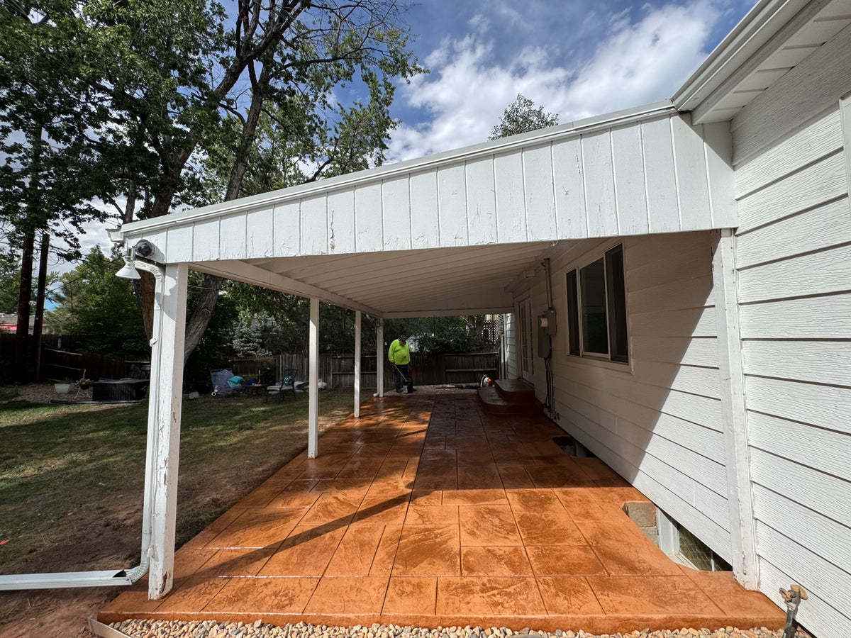 Newly installed stamped concrete patio and textured steps featuring an Ashlar Cut Slate pattern and custom two-tone concrete finish.