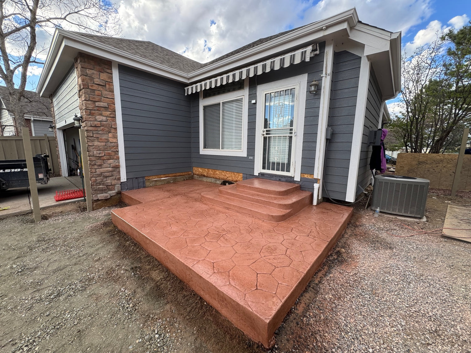 Finished stamped concrete patio with random stone pattern and steps in Denver Colorado by Pristine Concrete Denver